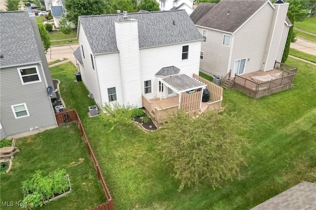 189 Booth Bay Dr, Medina, OH 44256 - rear view of house with a chimney, a deck, a shingled roof, central AC, and a lawn