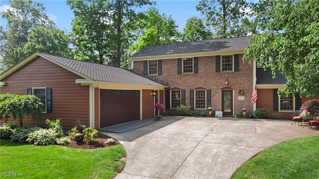 177 N Park Dr, Aurora, OH 44202 - colonial-style house featuring an attached garage, concrete driveway, brick siding, a shingled roof, and a front yard