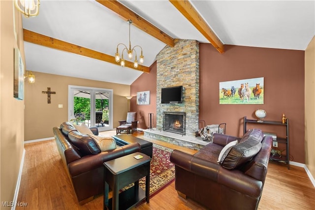 177 N Park Dr, Aurora, OH 44202 - living room with wood finished floors, a fireplace, and a chandelier