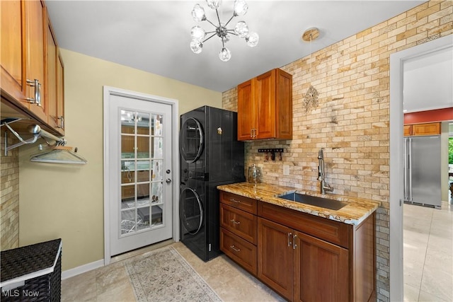 177 N Park Dr, Aurora, OH 44202 - kitchen with estacked washer and dryer, high quality fridge, tasteful backsplash, a chandelier, and light stone countertops