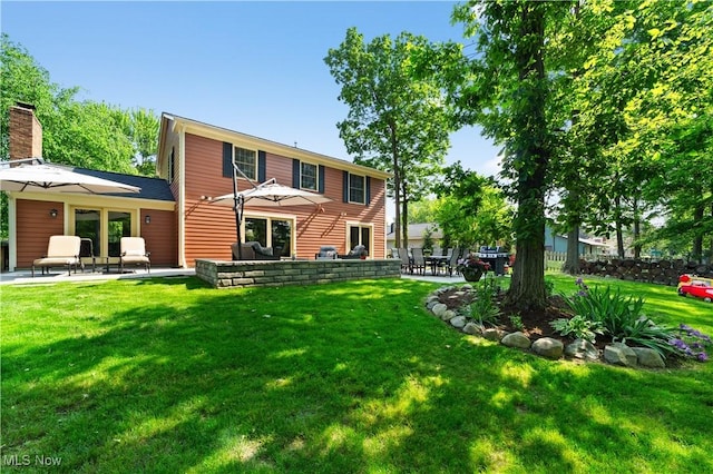 177 N Park Dr, Aurora, OH 44202 - rear view of house with a patio area, a yard, and a chimney