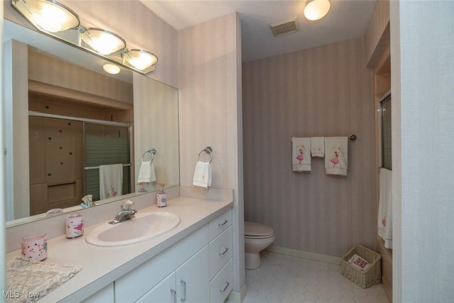 30965 Woodall, Solon, OH 44139 - bathroom featuring a shower with shower door, toilet, vanity, wallpapered walls, and tile patterned flooring