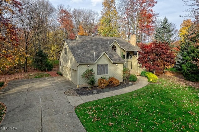 30965 Woodall, Solon, OH 44139 - view of front facade featuring concrete driveway, a chimney, a front yard, and roof with shingles