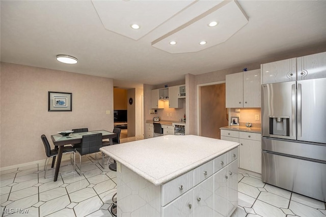 30965 Woodall, Solon, OH 44139 - kitchen featuring stainless steel fridge with ice dispenser, a kitchen island, light countertops, recessed lighting, and baseboards
