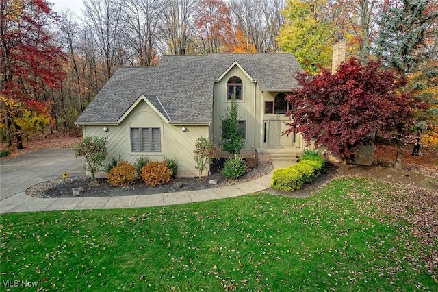 30965 Woodall, Solon, OH 44139 - traditional-style home featuring roof with shingles, a chimney, and a front lawn