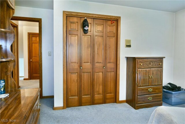 6739 Stewart Sharon Rd, Brookfield, OH 44403 - carpeted bedroom featuring a closet and baseboards