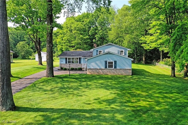 6739 Stewart Sharon Rd, Brookfield, OH 44403 - tri-level home with a chimney, a front yard, and brick siding