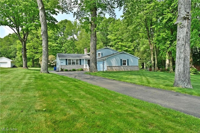 6739 Stewart Sharon Rd, Brookfield, OH 44403 - tri-level home with a chimney, asphalt driveway, a front yard, and a garage
