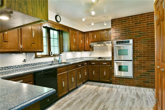 6739 Stewart Sharon Rd, Brookfield, OH 44403 - kitchen featuring appliances with stainless steel finishes, a sink, under cabinet range hood, light wood-type flooring, and dark countertops
