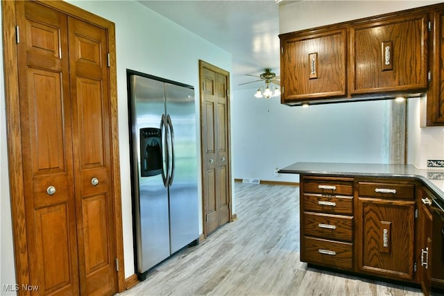 6739 Stewart Sharon Rd, Brookfield, OH 44403 - kitchen featuring stainless steel refrigerator with ice dispenser, a ceiling fan, light wood finished floors, baseboards, and dark countertops
