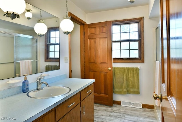 6739 Stewart Sharon Rd, Brookfield, OH 44403 - full bath featuring a shower with shower door, vanity, wood finished floors, and baseboards