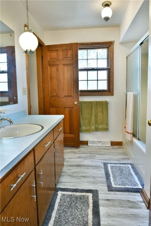6739 Stewart Sharon Rd, Brookfield, OH 44403 - full bathroom featuring plenty of natural light, vanity, wood finished floors, and enclosed tub / shower combo