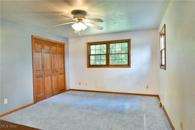 6739 Stewart Sharon Rd, Brookfield, OH 44403 - unfurnished bedroom with carpet flooring, baseboards, a closet, and ceiling fan