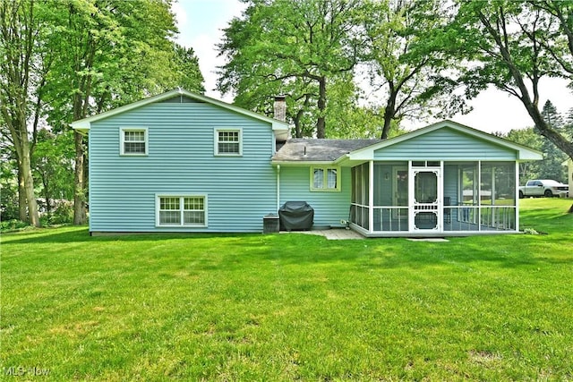 6739 Stewart Sharon Rd, Brookfield, OH 44403 - rear view of property with a chimney, a sunroom, and a lawn