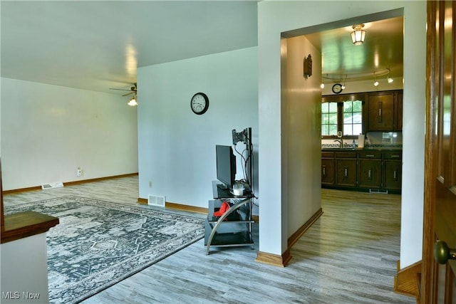 6739 Stewart Sharon Rd, Brookfield, OH 44403 - living room with light wood-type flooring, a ceiling fan, and baseboards