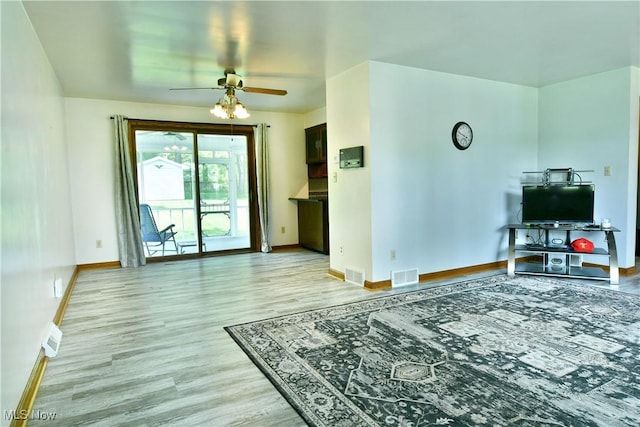 6739 Stewart Sharon Rd, Brookfield, OH 44403 - living room featuring a ceiling fan, light wood finished floors, and baseboards