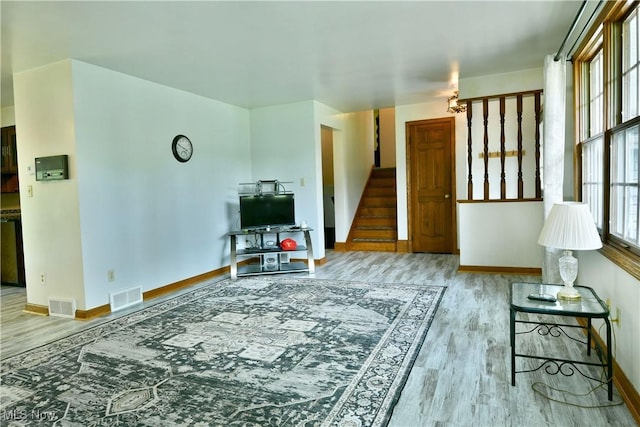 6739 Stewart Sharon Rd, Brookfield, OH 44403 - living room with wood finished floors, stairway, and baseboards
