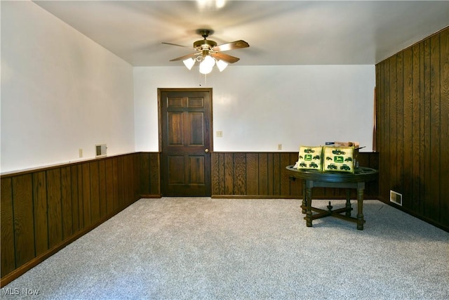 6739 Stewart Sharon Rd, Brookfield, OH 44403 - sitting room featuring wooden walls, ceiling fan, a wainscoted wall, and carpet flooring