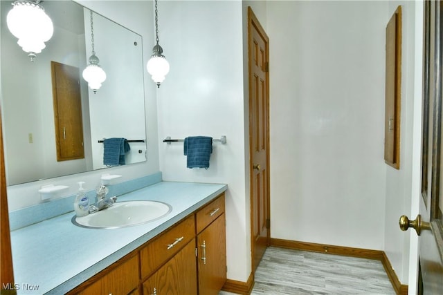 6739 Stewart Sharon Rd, Brookfield, OH 44403 - bathroom with vanity, wood finished floors, and baseboards