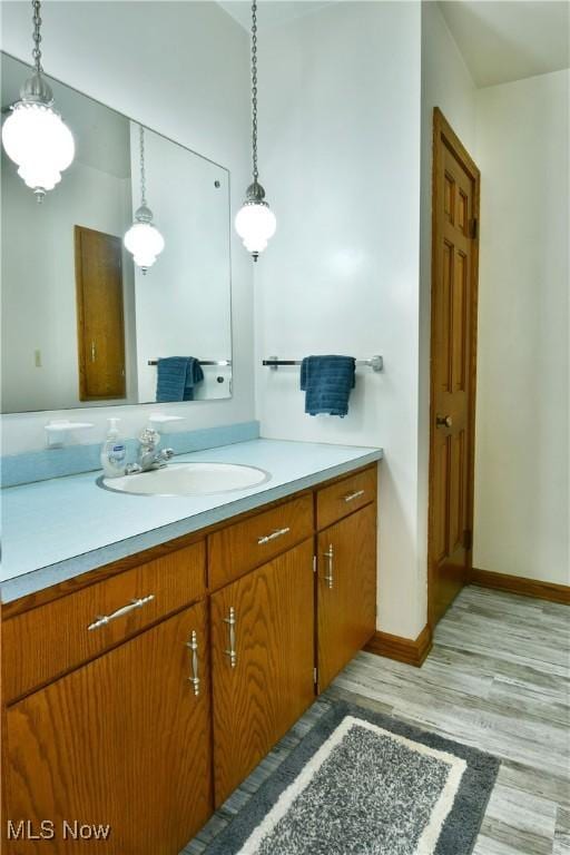 6739 Stewart Sharon Rd, Brookfield, OH 44403 - bathroom featuring vanity, wood finished floors, and baseboards