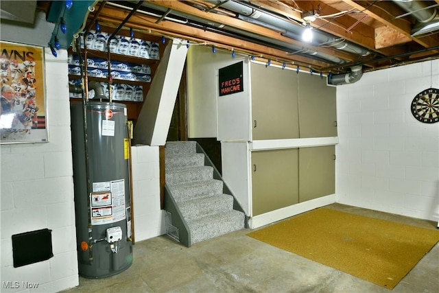 6739 Stewart Sharon Rd, Brookfield, OH 44403 - unfinished below grade area featuring gas water heater, concrete block wall, and stairway