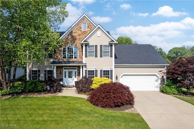400 Meadow Ridge Trl, Doylestown, OH 44230 - traditional home featuring stone siding, a front lawn, a garage, and driveway