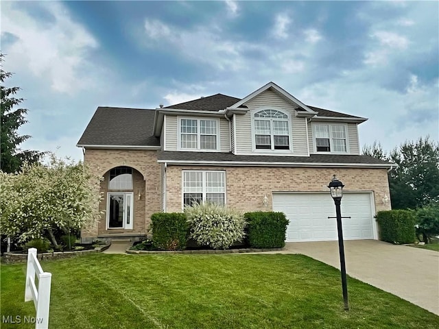 6005 Champagne, Medina, OH 44256 - traditional home with concrete driveway, an attached garage, a front lawn, and brick siding