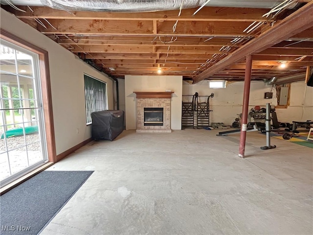6005 Champagne, Medina, OH 44256 - basement with electric panel, plenty of natural light, and a brick fireplace