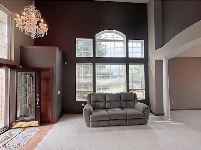6005 Champagne, Medina, OH 44256 - living area with decorative columns, a chandelier, a high ceiling, and baseboards