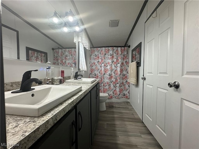 301 46th St SW, Canton, OH 44706 - bathroom featuring vanity, crown molding, toilet, wood finished floors, and a shower with curtain