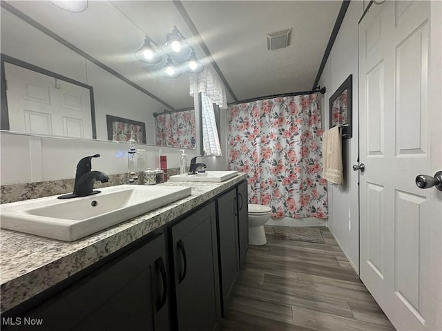301 46th St SW, Canton, OH 44706 - bathroom featuring ornamental molding, double vanity, toilet, wood finished floors, and curtained shower