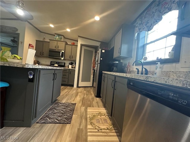 301 46th St SW, Canton, OH 44706 - kitchen with stainless steel appliances, gray cabinetry, light wood finished floors, light countertops, and crown molding