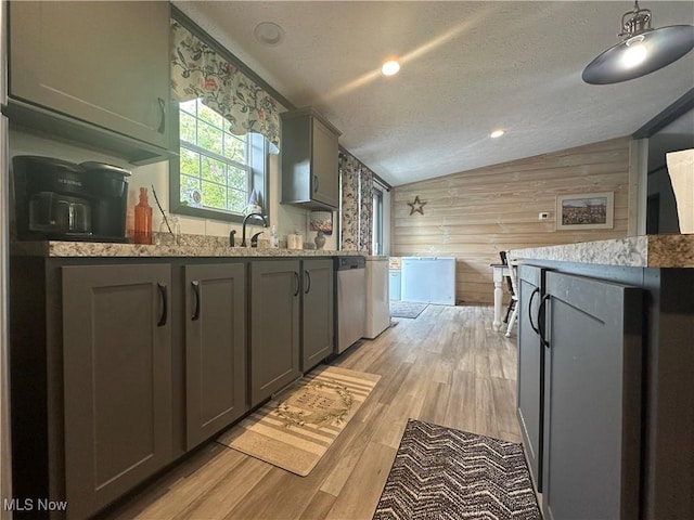 301 46th St SW, Canton, OH 44706 - kitchen with lofted ceiling, wood walls, gray cabinetry, light stone countertops, and stainless steel dishwasher