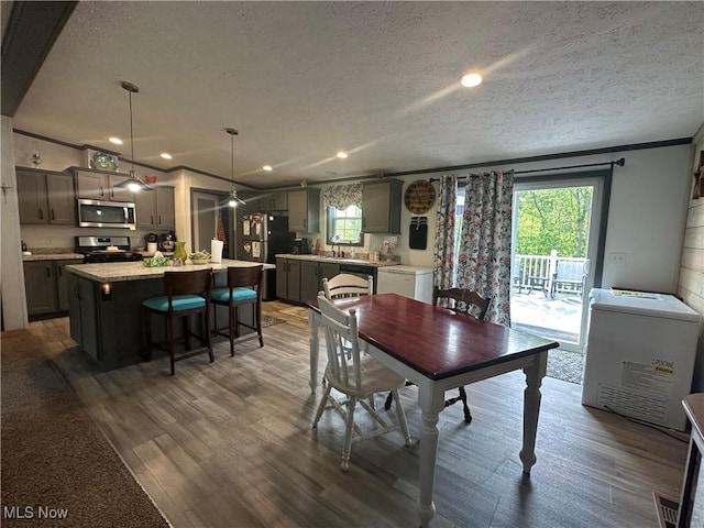 301 46th St SW, Canton, OH 44706 - dining space with a textured ceiling, crown molding, wood finished floors, and recessed lighting