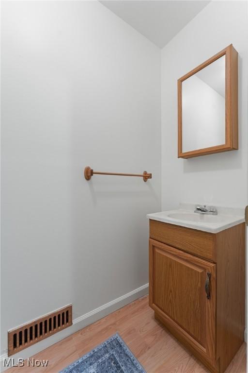 7183 Hunter Dr, Chippewa Lake, OH 44215 - bathroom featuring wood finished floors, vanity, and baseboards