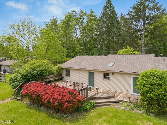 7183 Hunter Dr, Chippewa Lake, OH 44215 - rear view of house featuring a deck, a yard, and roof with shingles