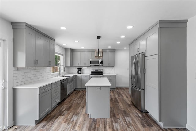 1892 Toepfer Rd, Akron, OH 44312 - kitchen with appliances with stainless steel finishes, gray cabinetry, a sink, a center island, and light countertops