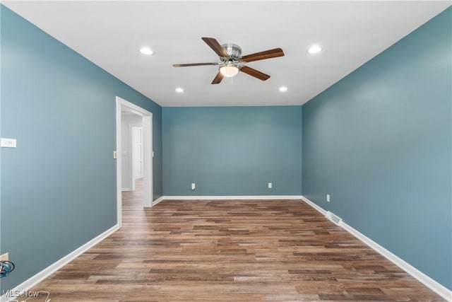 1892 Toepfer Rd, Akron, OH 44312 - empty room with a ceiling fan, wood finished floors, recessed lighting, and baseboards