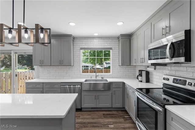 1892 Toepfer Rd, Akron, OH 44312 - kitchen with appliances with stainless steel finishes, gray cabinets, a sink, tasteful backsplash, and recessed lighting
