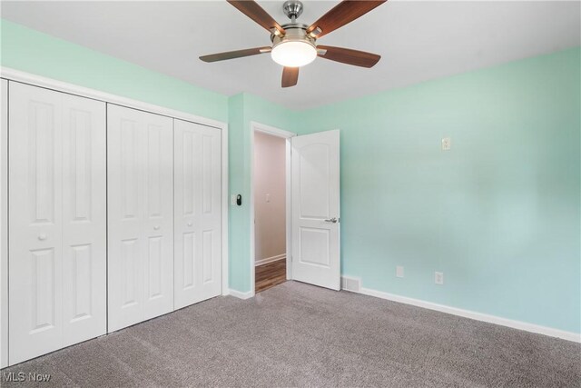 1892 Toepfer Rd, Akron, OH 44312 - unfurnished bedroom with carpet, a closet, baseboards, and a ceiling fan