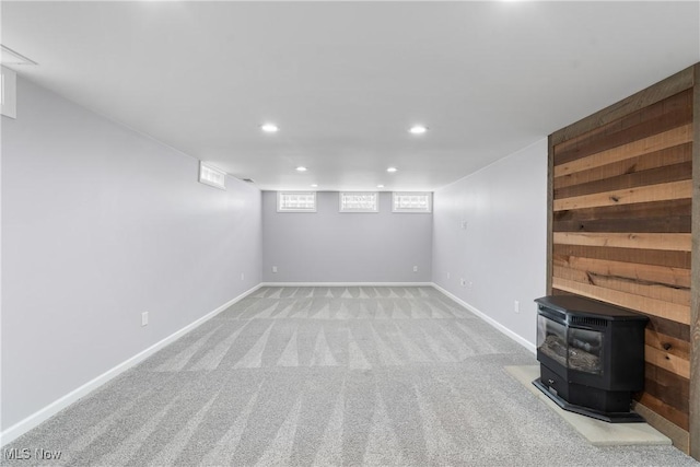 1892 Toepfer Rd, Akron, OH 44312 - basement with recessed lighting, a wood stove, light colored carpet, and baseboards