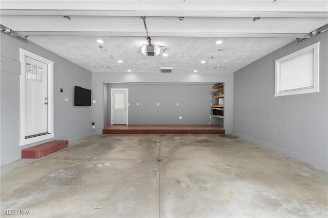 1892 Toepfer Rd, Akron, OH 44312 - garage with a garage door opener, recessed lighting, and baseboards