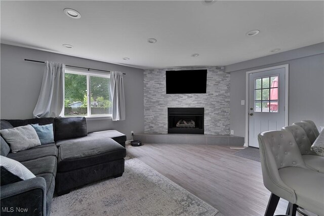 1094 Jessie Ave, Kent, OH 44240 - living area with plenty of natural light, a tiled fireplace, wood finished floors, and recessed lighting