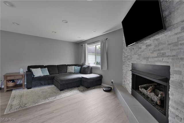 1094 Jessie Ave, Kent, OH 44240 - living area featuring wood finished floors, baseboards, a stone fireplace, and recessed lighting