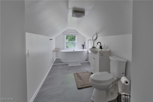 1094 Jessie Ave, Kent, OH 44240 - bathroom with a freestanding tub, lofted ceiling, toilet, baseboards, and vanity