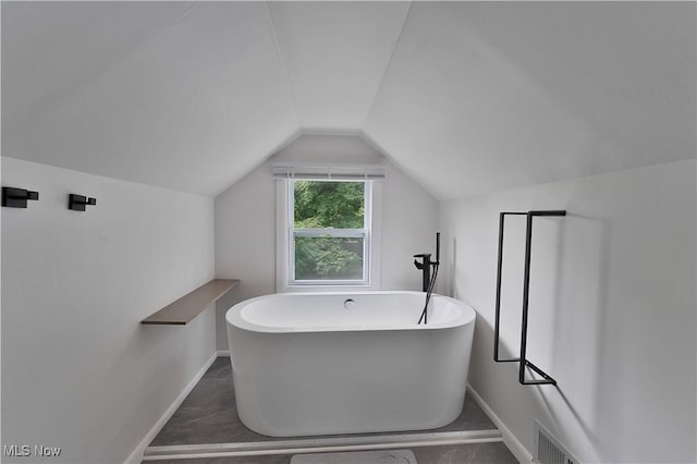 1094 Jessie Ave, Kent, OH 44240 - full bathroom featuring baseboards, a freestanding tub, and lofted ceiling