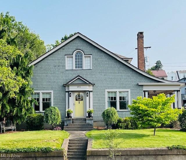 161 W Main St, New Concord, OH 43762 - view of front of house featuring a front yard and a chimney