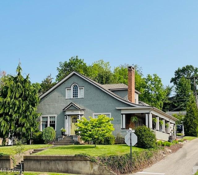 161 W Main St, New Concord, OH 43762 - view of front of house with a chimney and a front yard