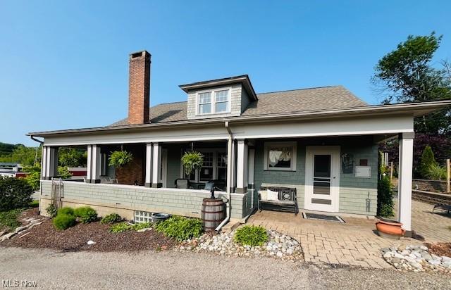 161 W Main St, New Concord, OH 43762 - view of front facade featuring a chimney