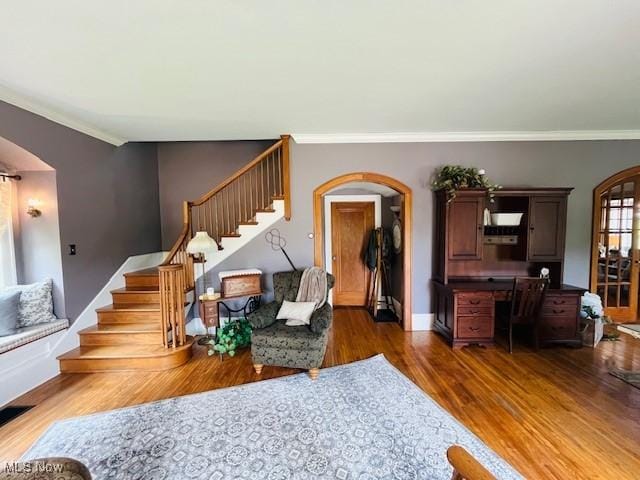 161 W Main St, New Concord, OH 43762 - living area featuring arched walkways, wood finished floors, stairs, crown molding, and baseboards